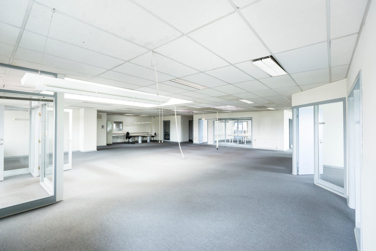 Modern commercial office space with glass partitions — tenant improvement buildout